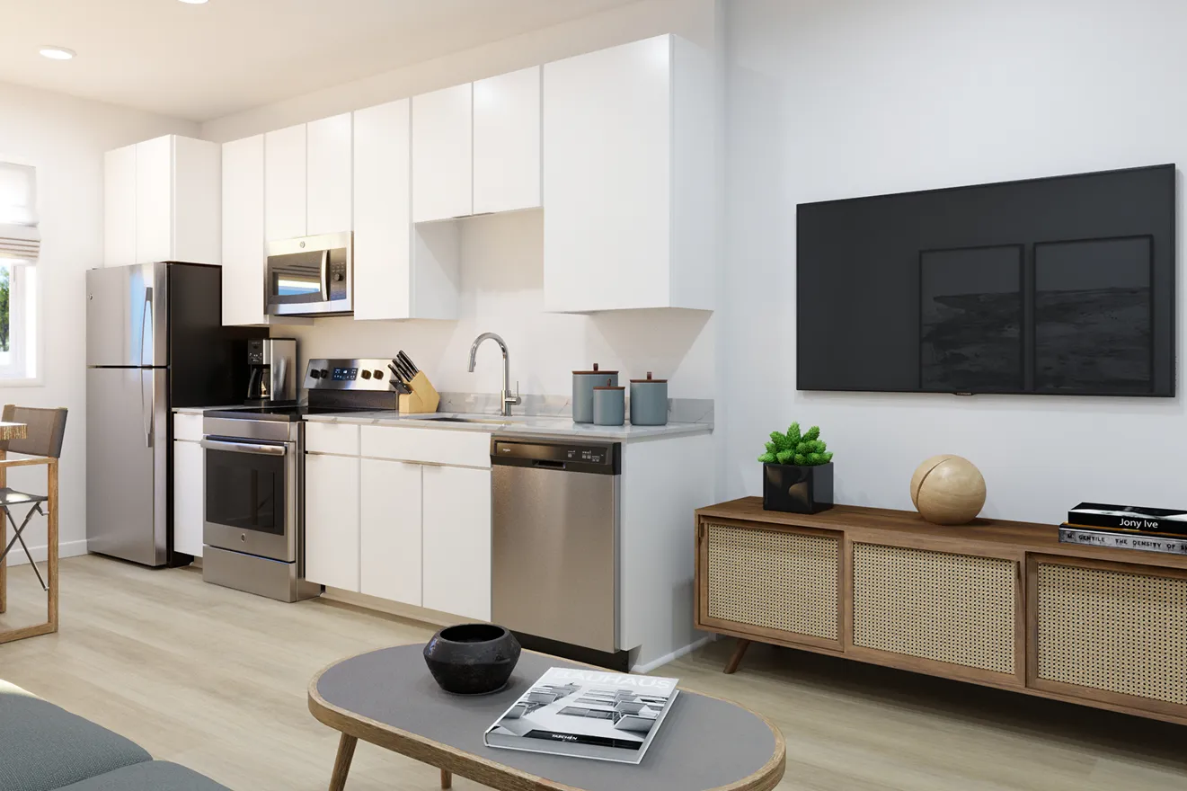 Modern kitchen and living area with sleek white cabinets, stainless steel appliances, a wooden TV stand, and decor including a small plant and a globe.